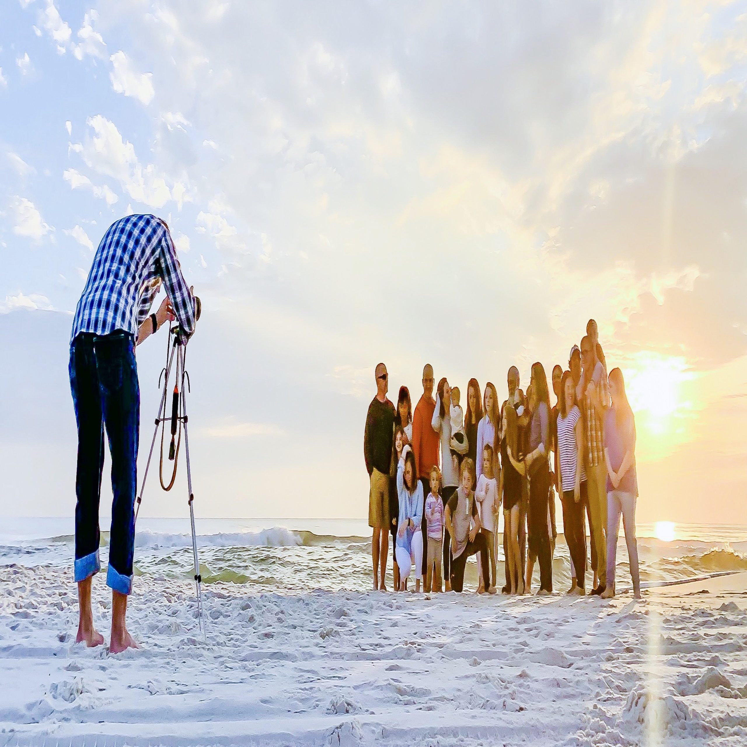 photo of a photographer taking a family picture on a beach