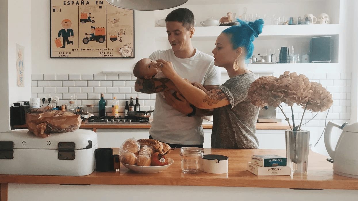 parents holding baby in the kitchen