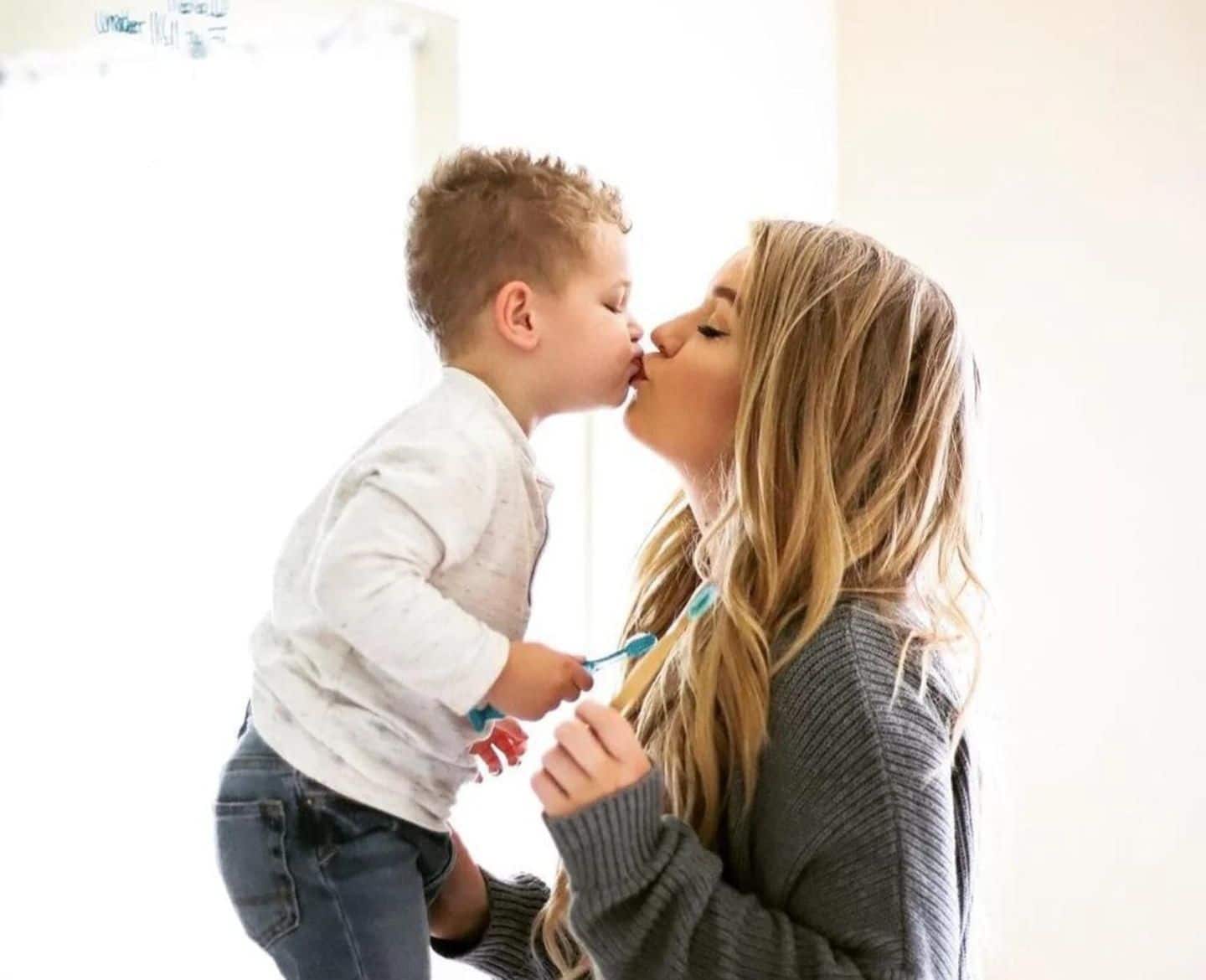 mom kissing son Motherly