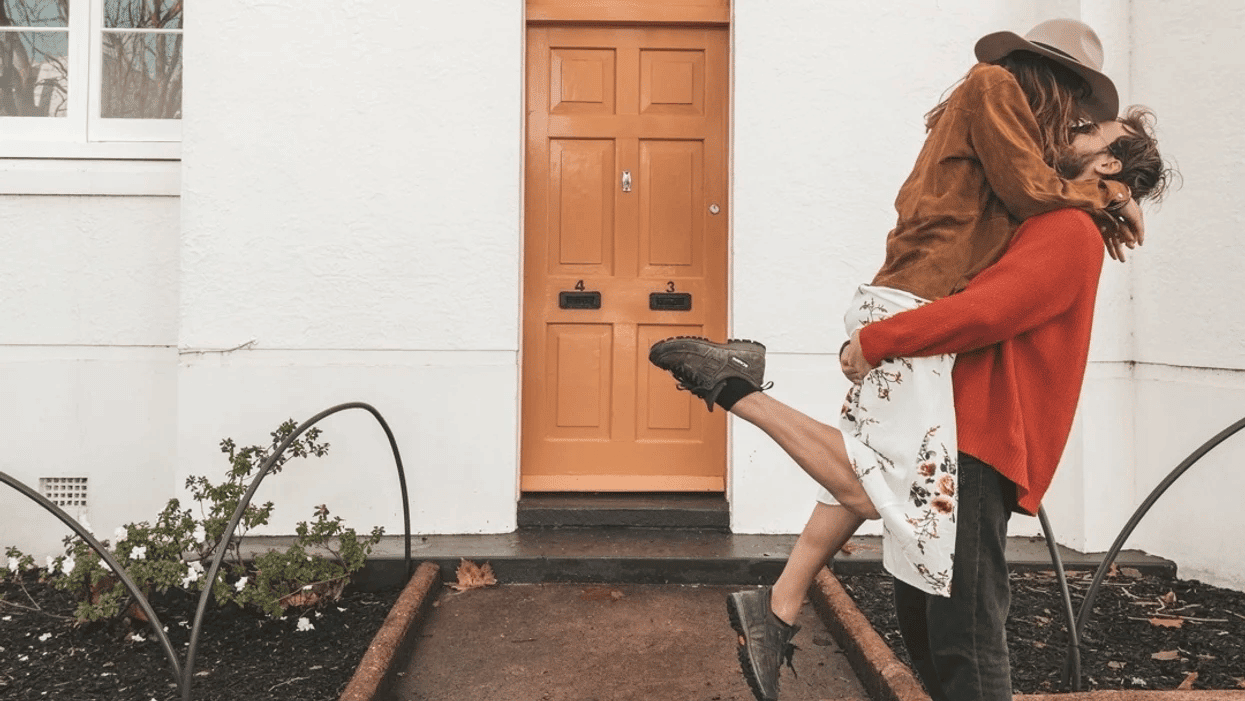 couple kissing outside of home