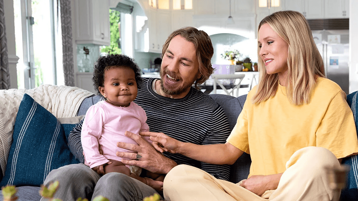 Kristen Bell and Dax Shepard holding baby