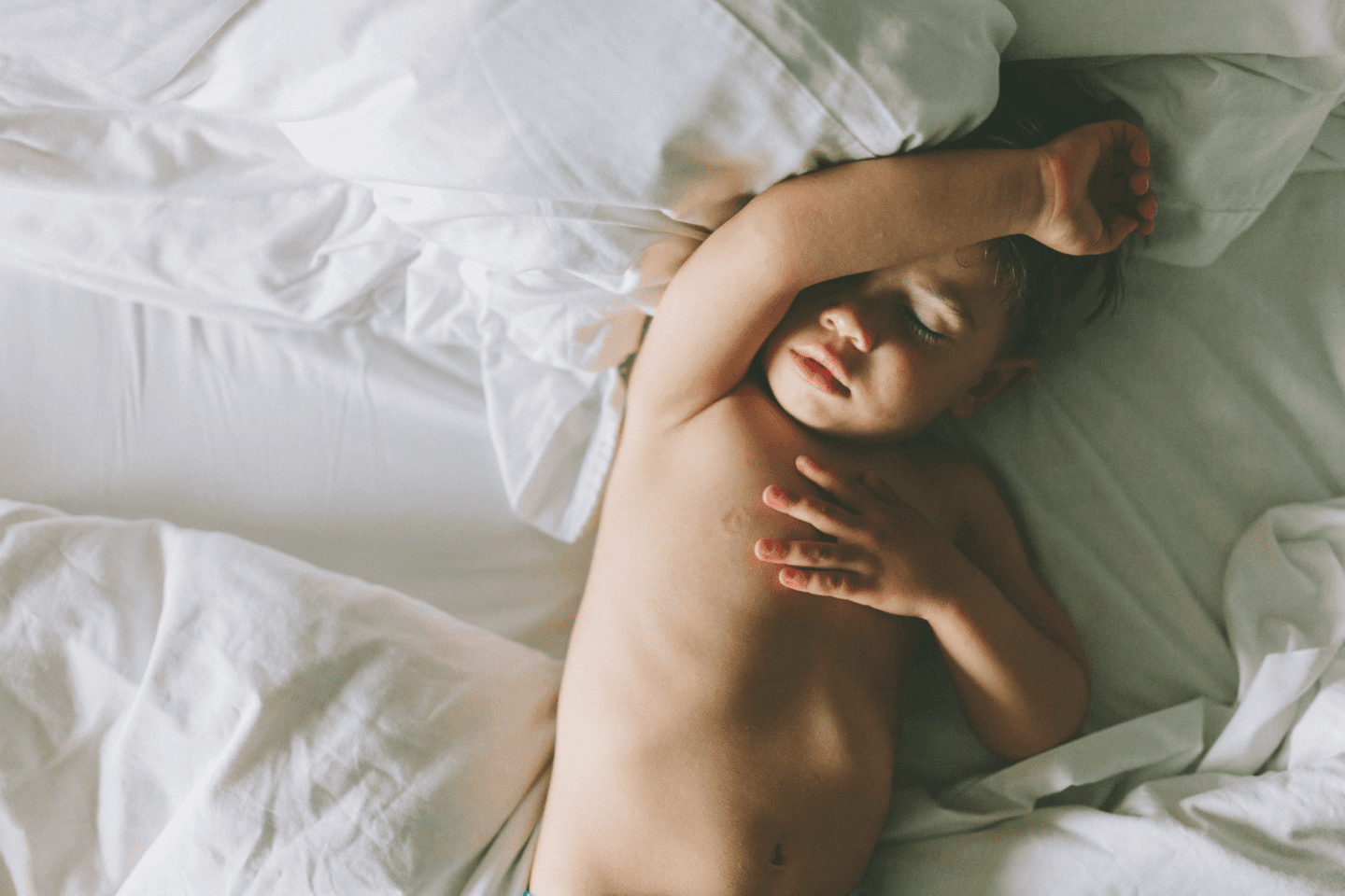 child sleeping in a bed - irregular bedtime
