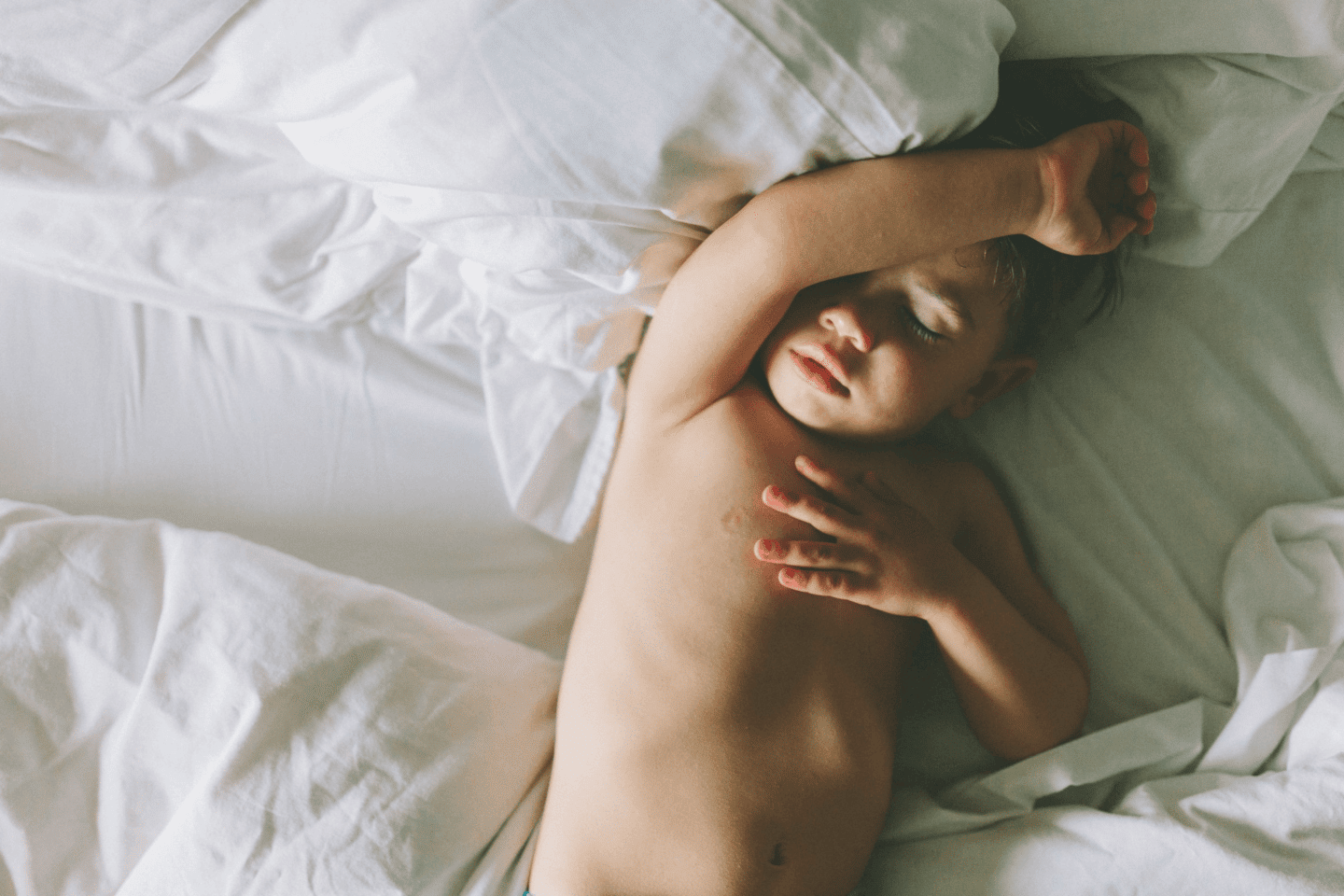 child sleeping in a bed