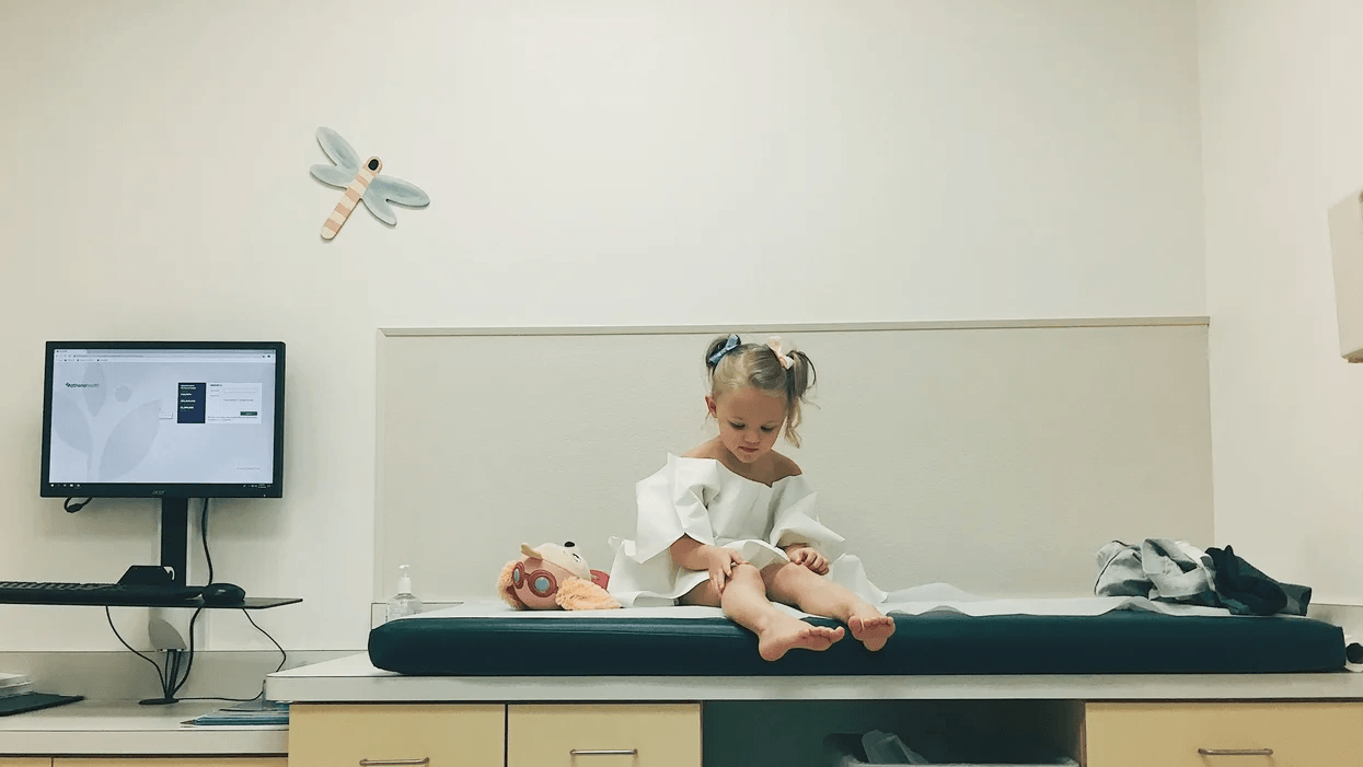 little girl sitting on a doctor's table