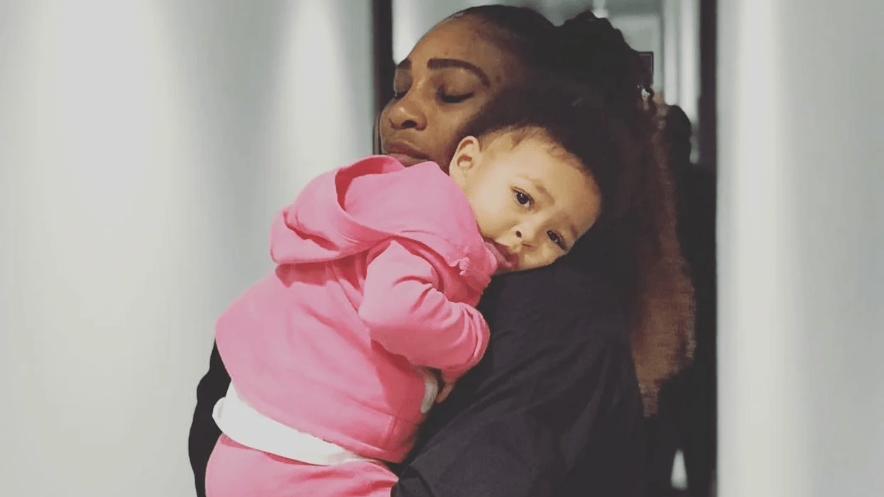 Serena Williams carrying daughter on shoulder