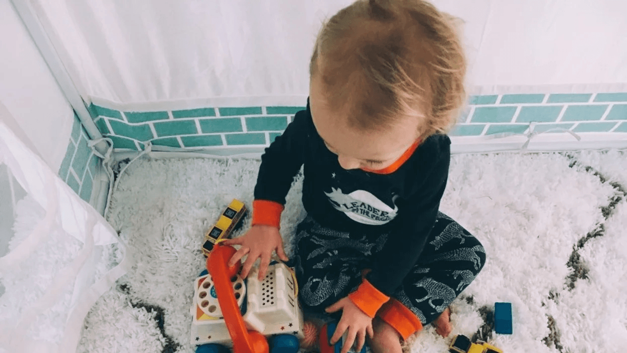 child playing with toys on the floor