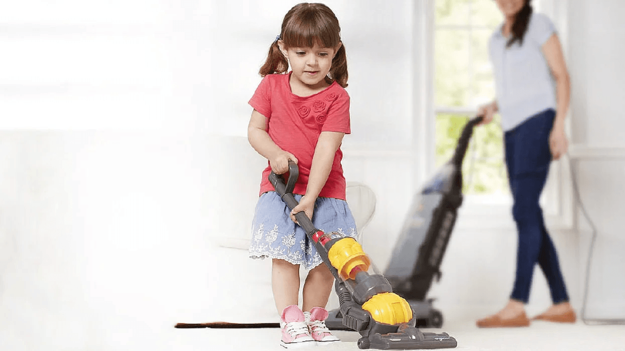 child vacuuming with a vacuum