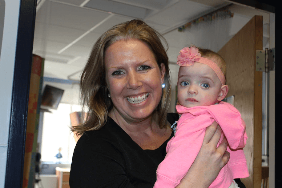 woman holding 5-month-old baby