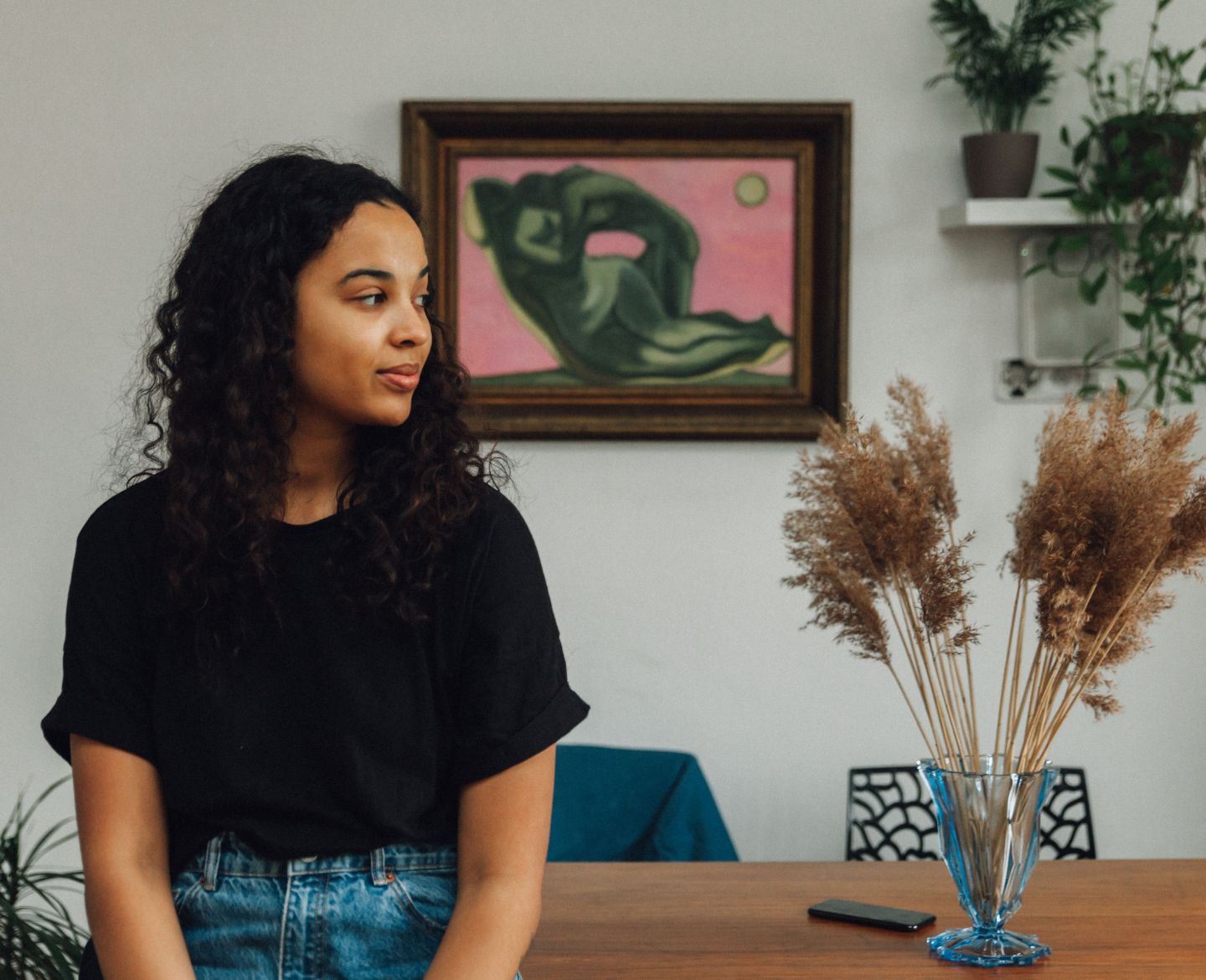 woman at home sitting on dining table looking away