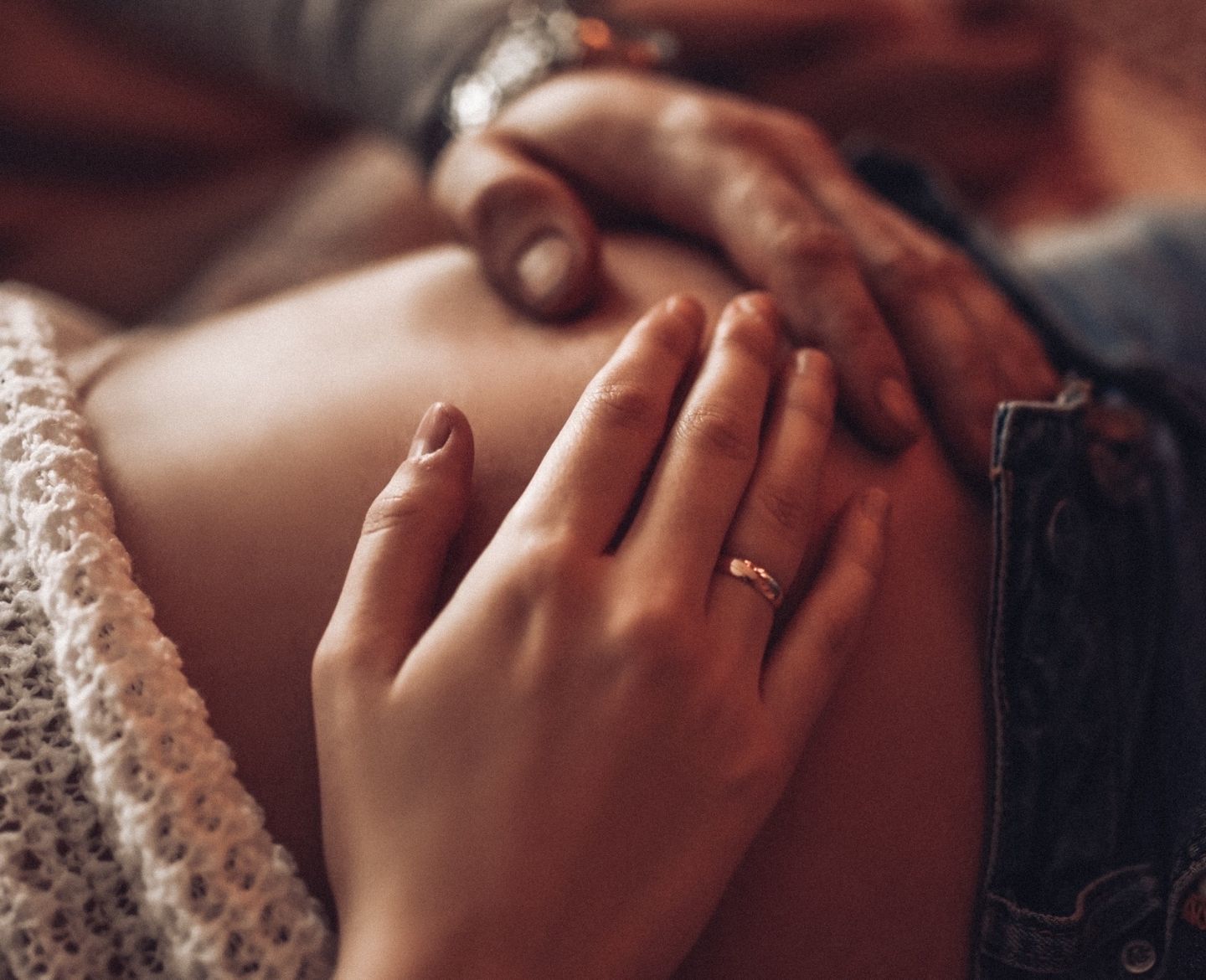 pregnant woman putting hands over her belly