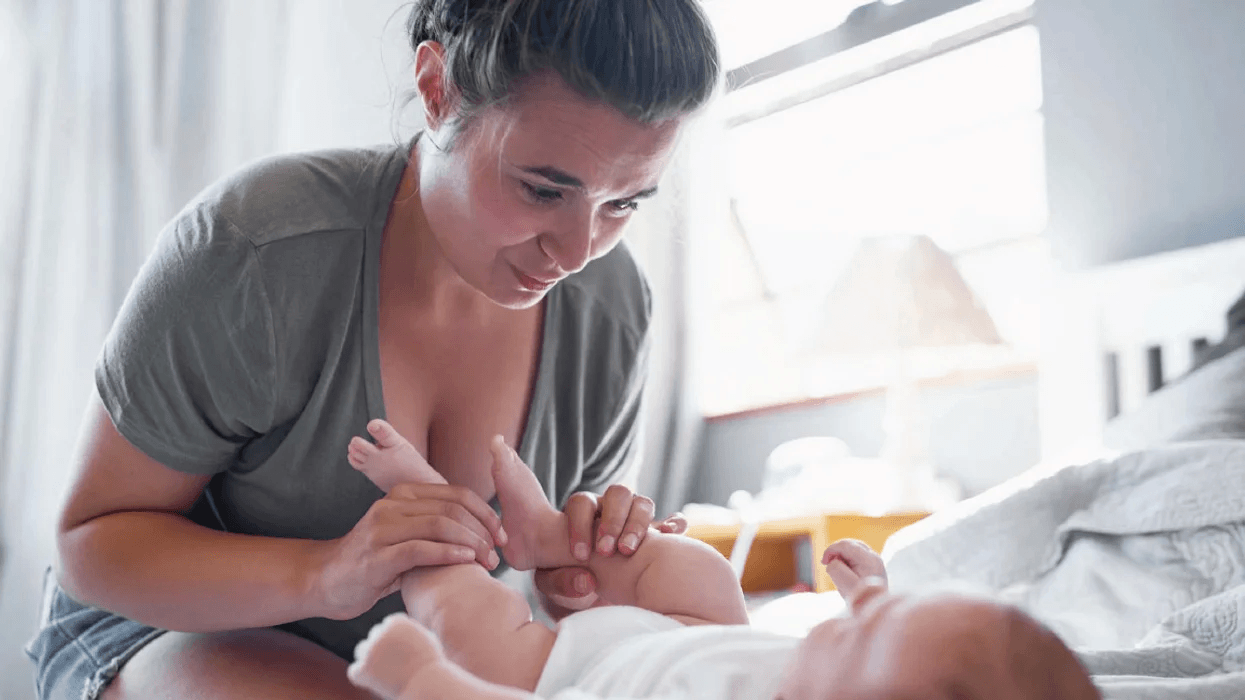 woman playing with baby legs