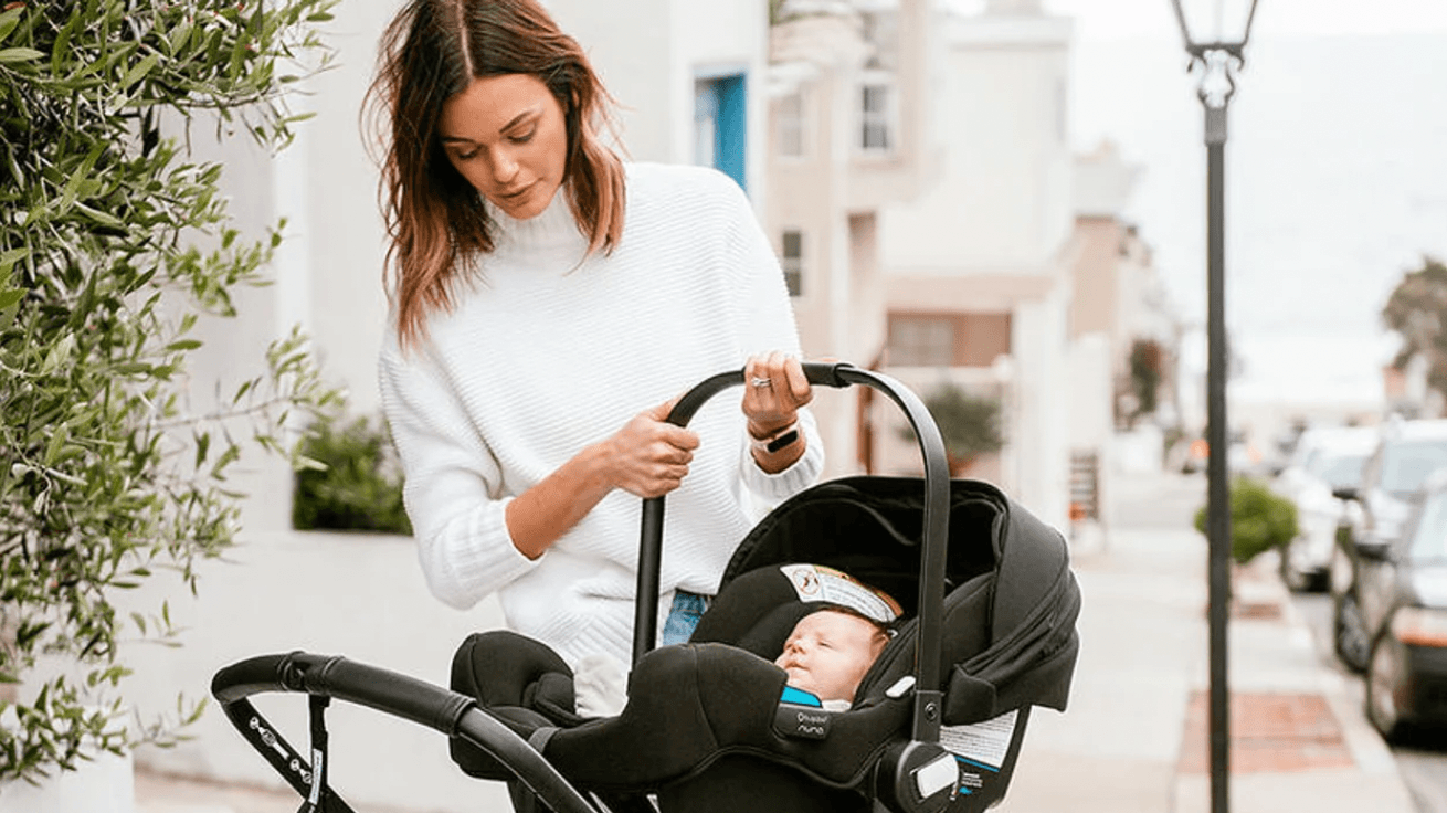 mom carrying a baby in a carseat