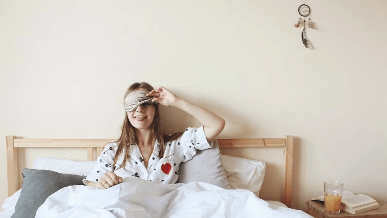 woman wearing a sleep mask in bed