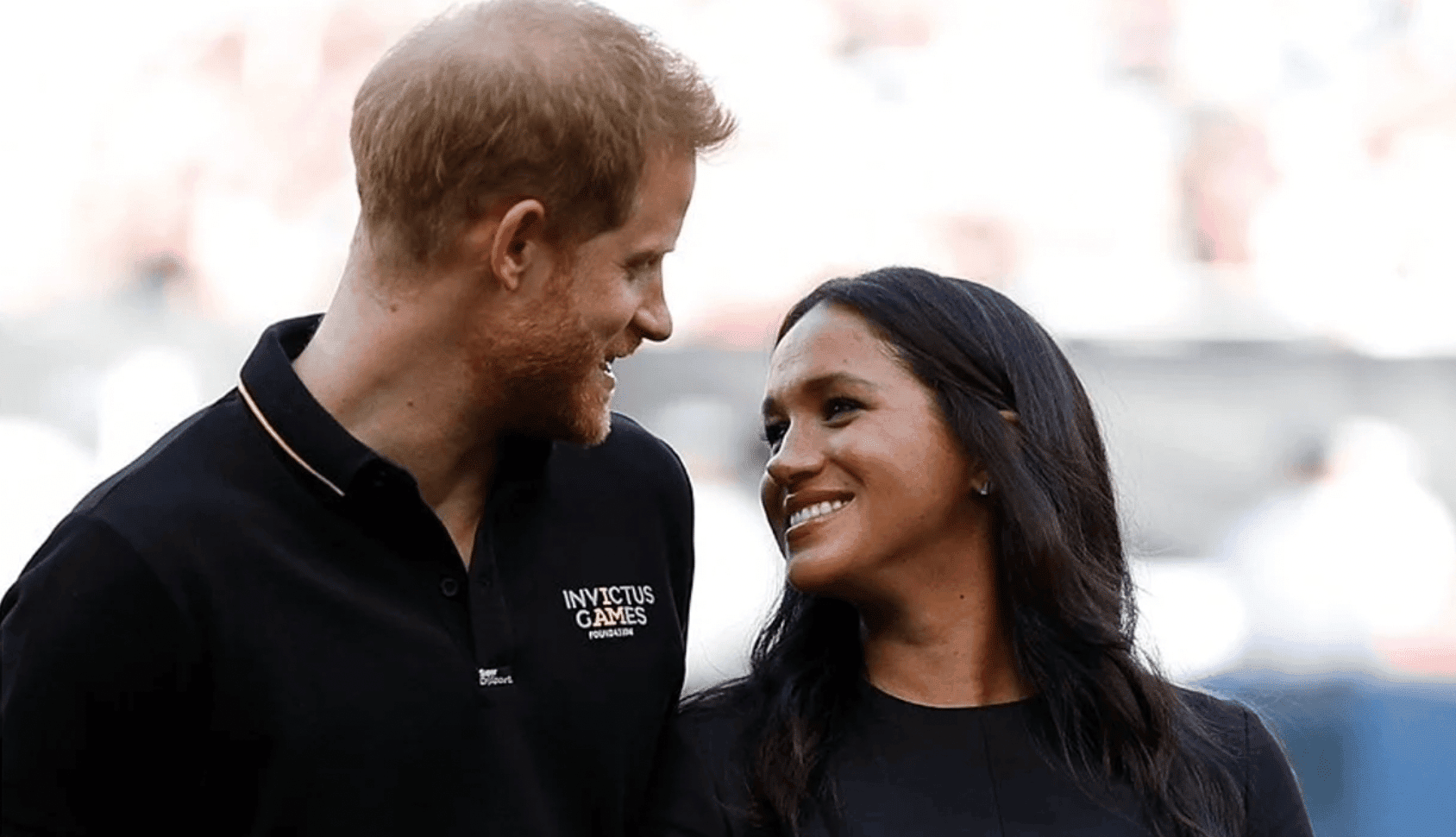 megan marke and prince harry smiling at each other