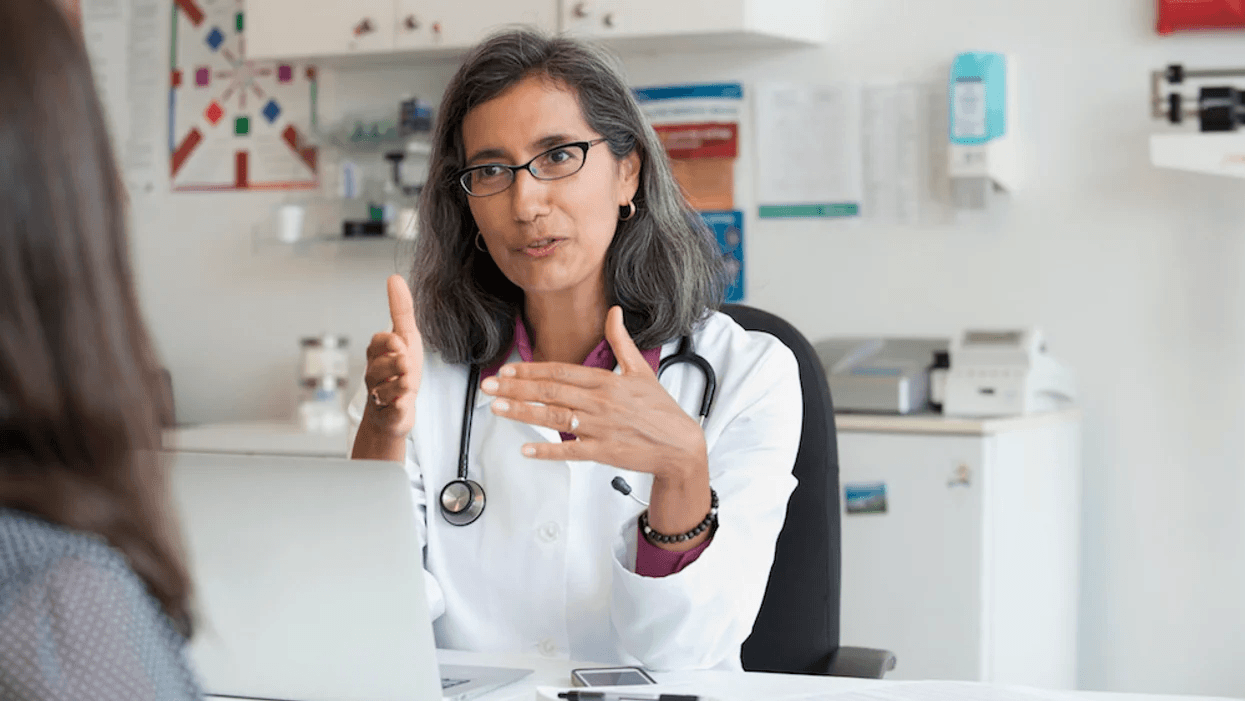 doctor talking to woman at her office