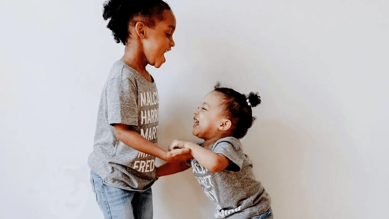 siblings holding hands and playing