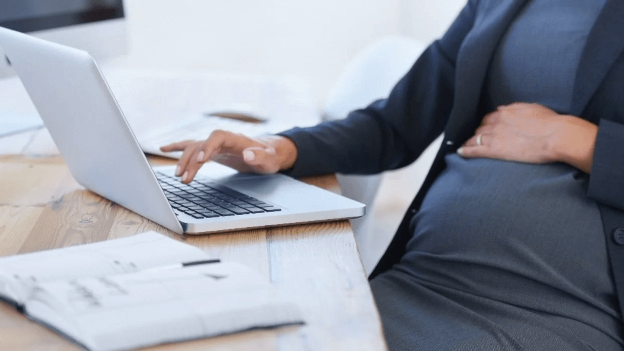pregnant woman working on a laptop- returning to work after maternity leave