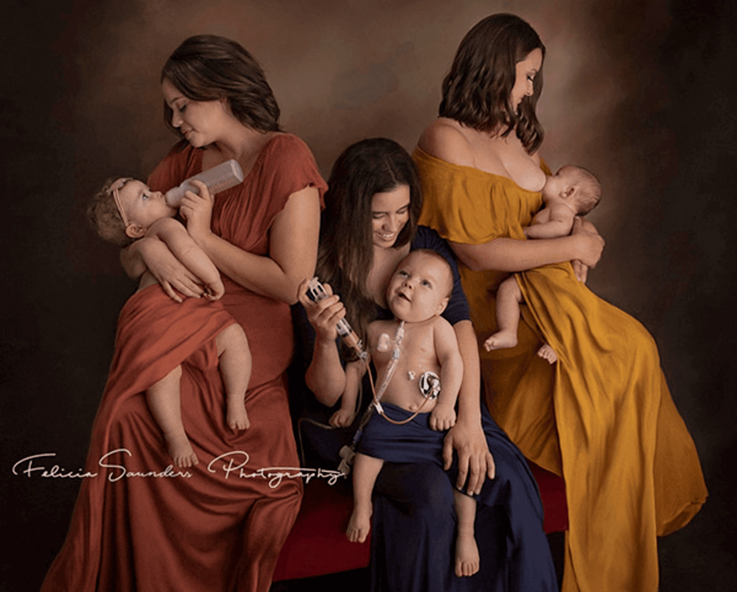 women holding their babies