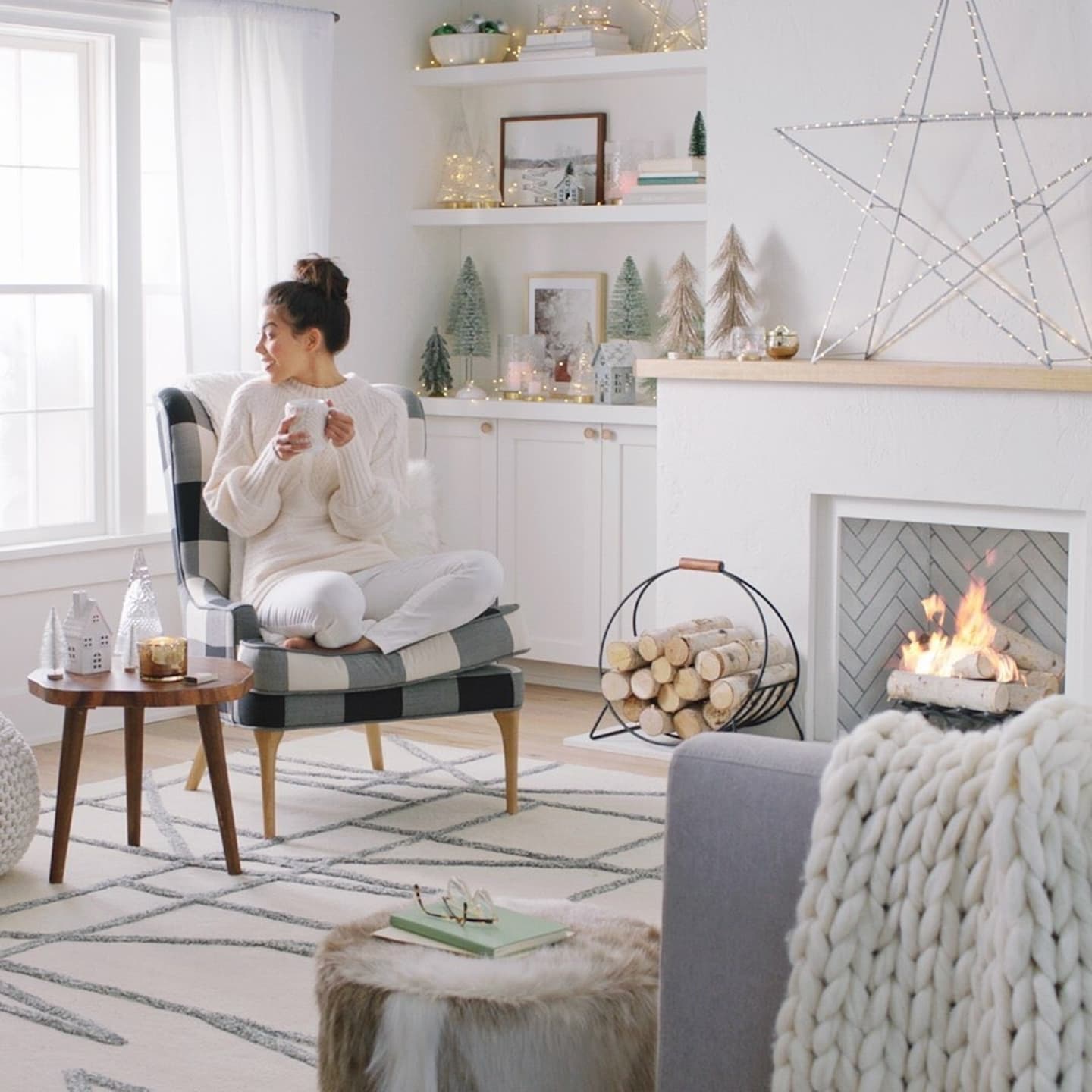 woman cozied up next to a fire