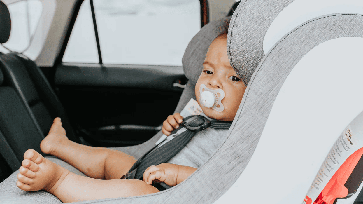 little baby sitting in a car seat - car seat expiration dates