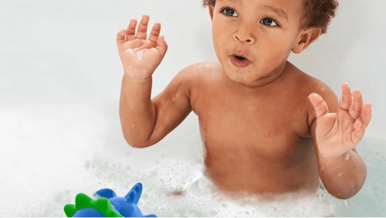 little boy playing in the bath