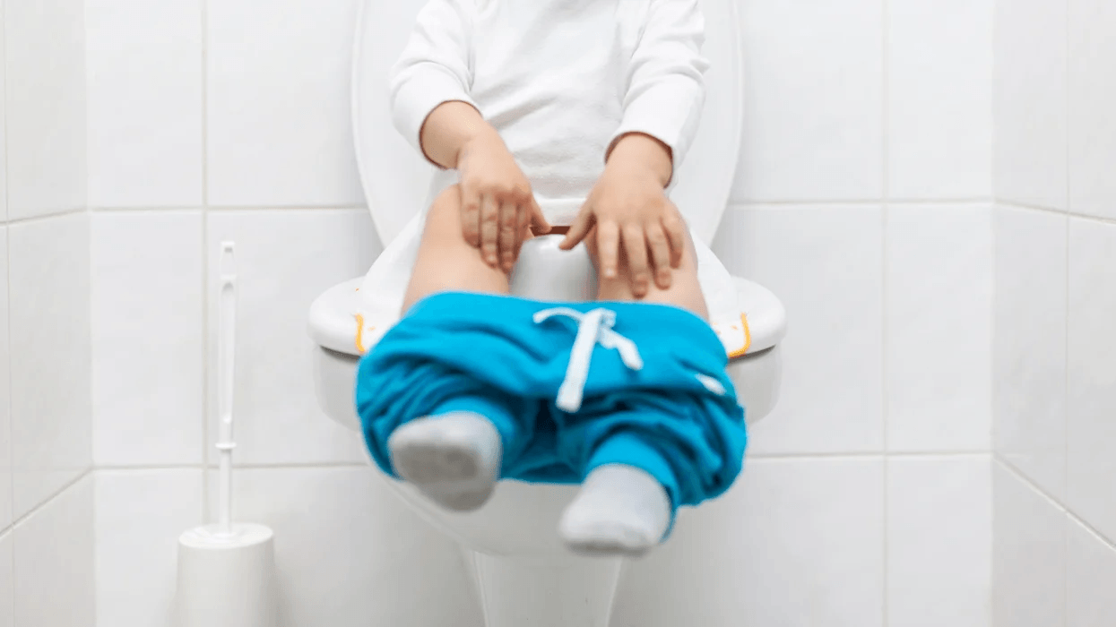 child sitting on the toilet