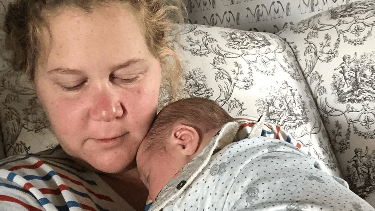 Amy Schumer holding her newborn son