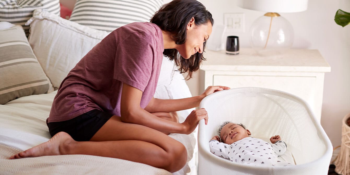 mom watching baby sleep practicing gentle sleep training