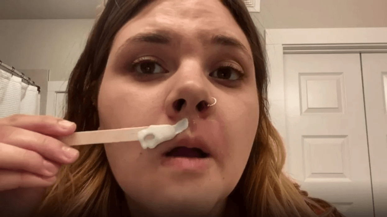 close-up photo of woman waxing mustache