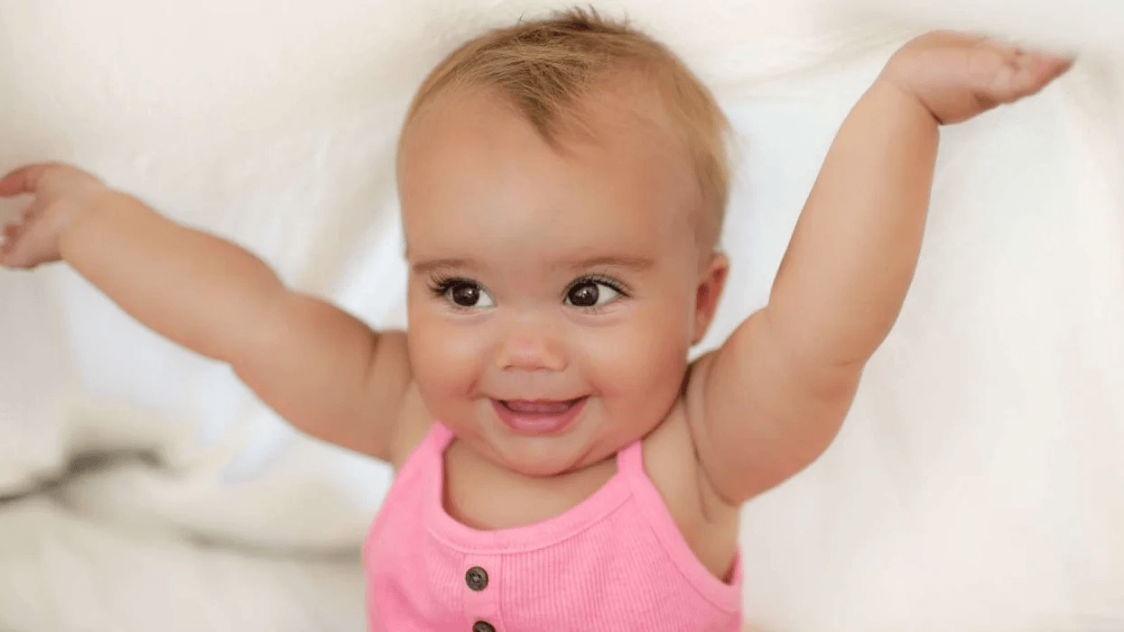 baby girl with arms in the air