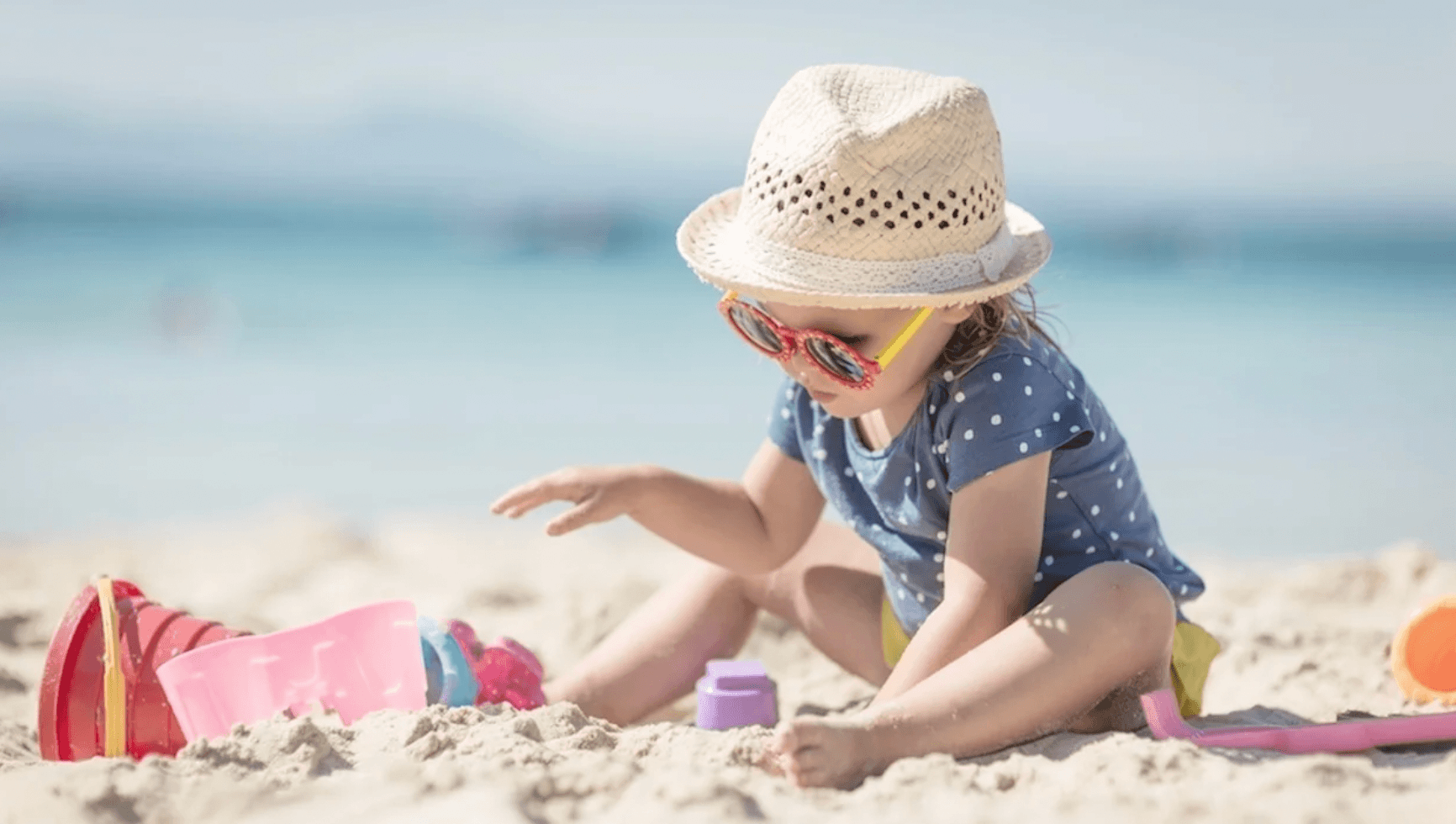 child playing in the sand