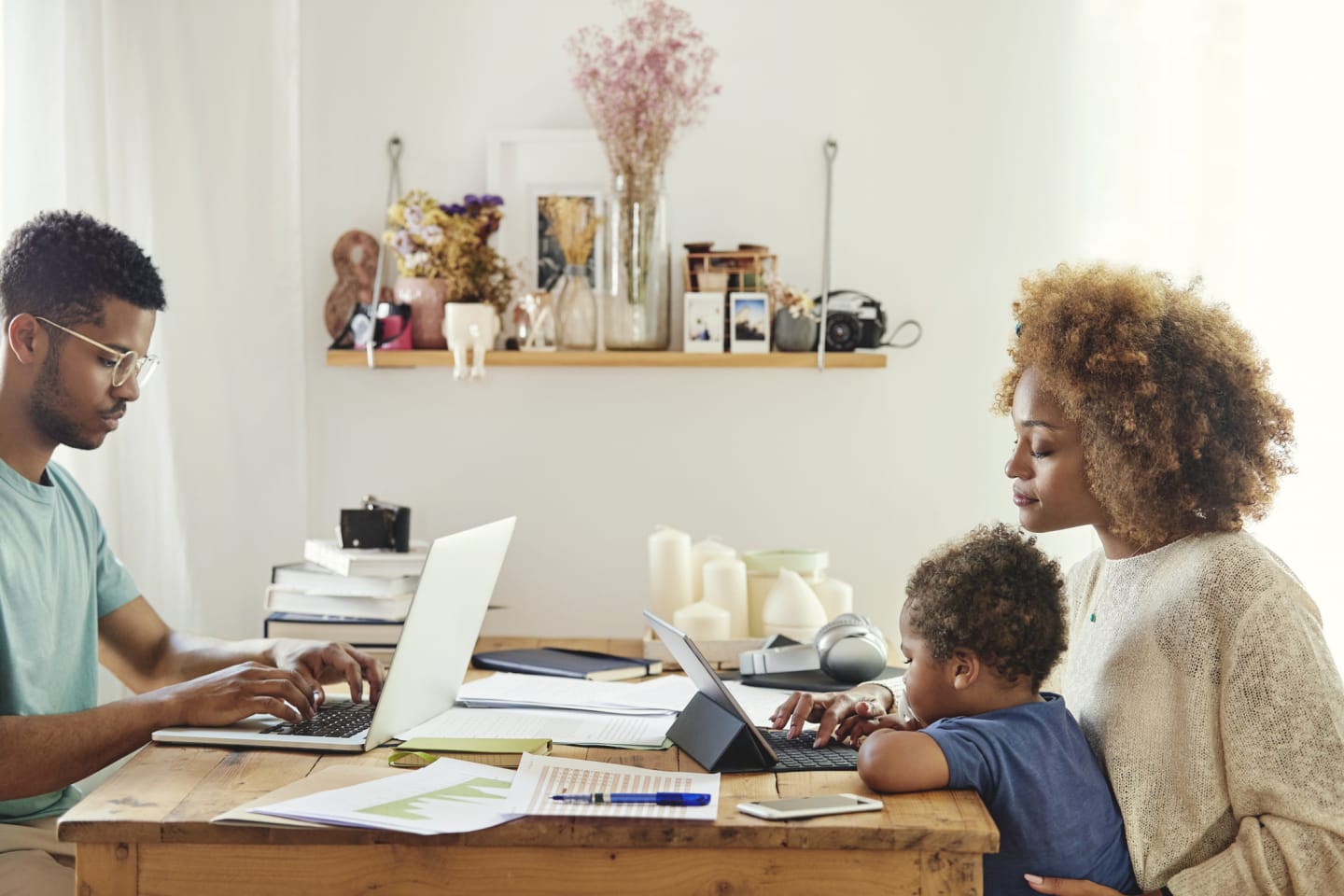 parents-on-computers-with-toddler-on-moms-lap