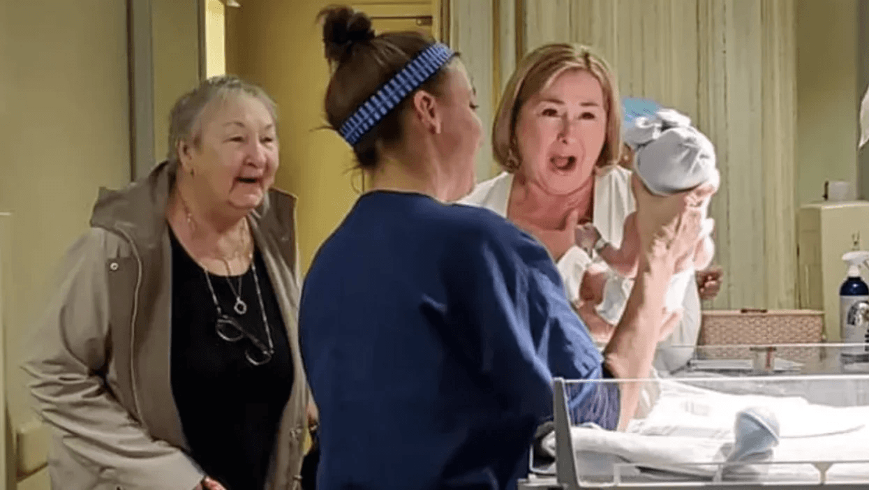 a grandma and a great grandma seeing their grandchild for the first time