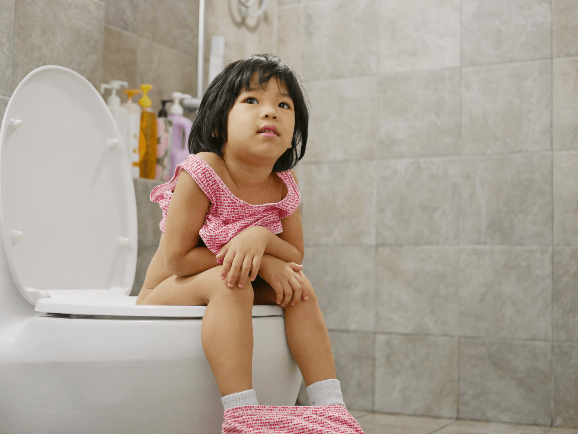 little girl sitting on the toilet