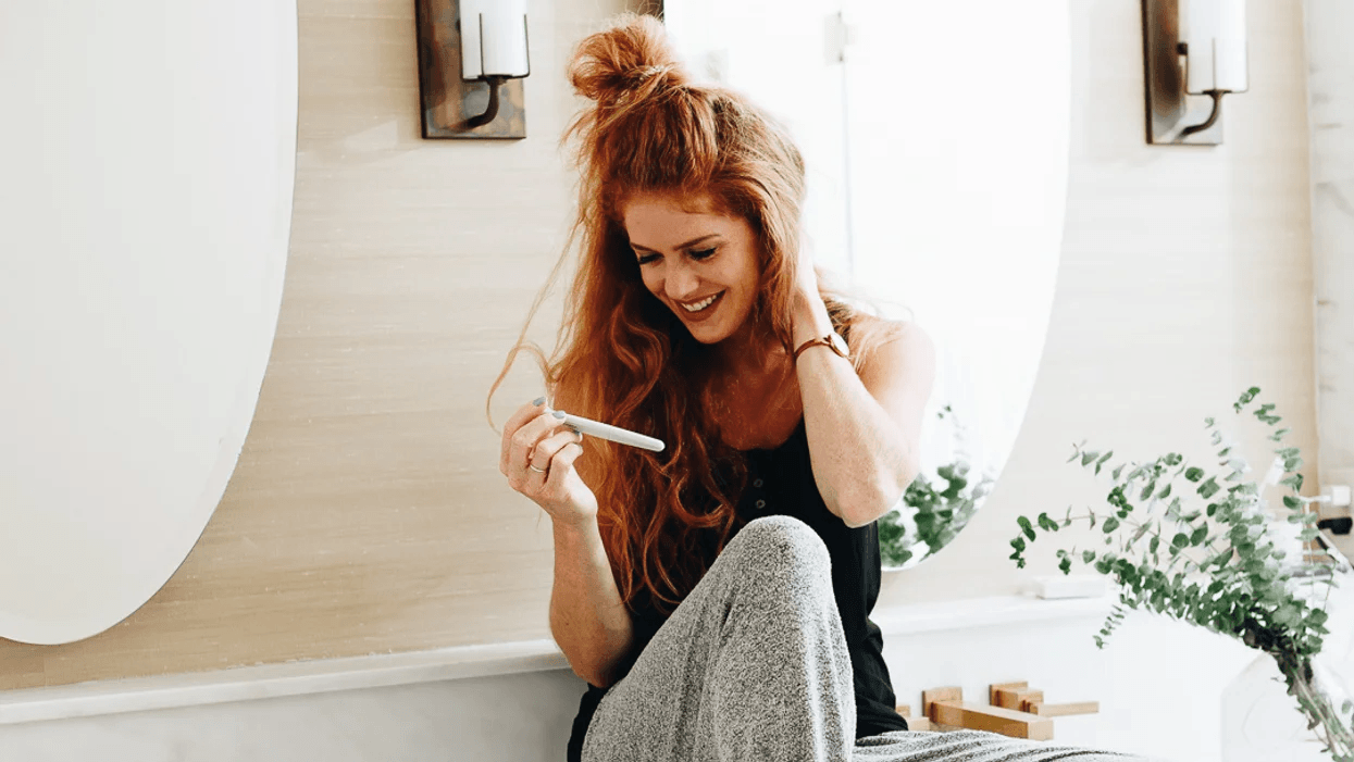 woman holding pregnancy test