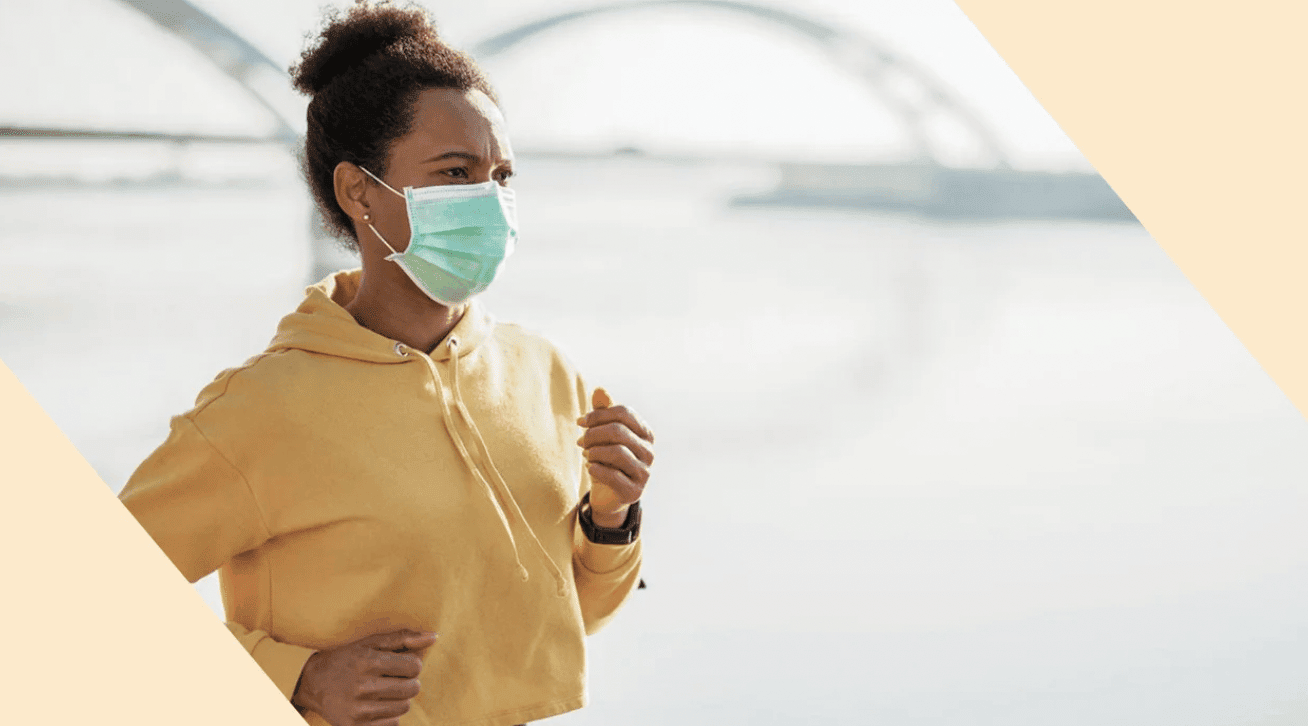 woman running with a face mask