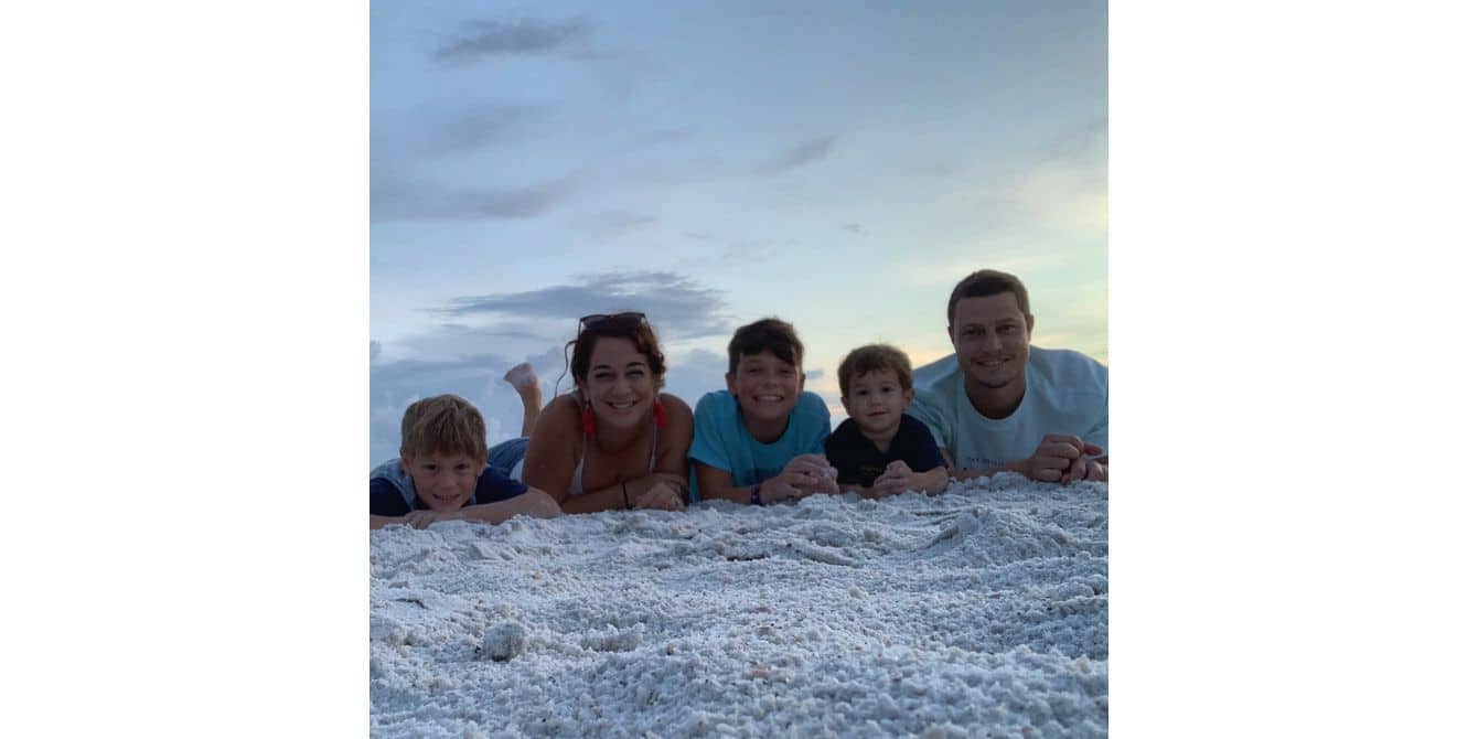 family laying on the beach sand - essay on how to confront past traumas