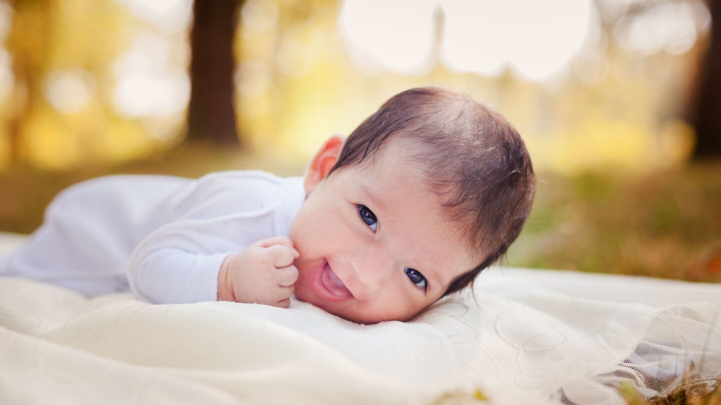 Newborn baby: September baby lying outside