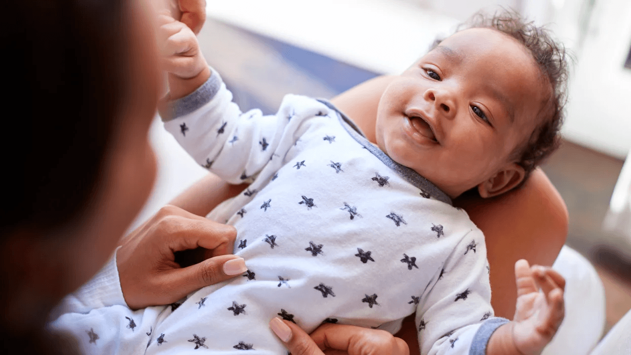 mom holding baby on lap