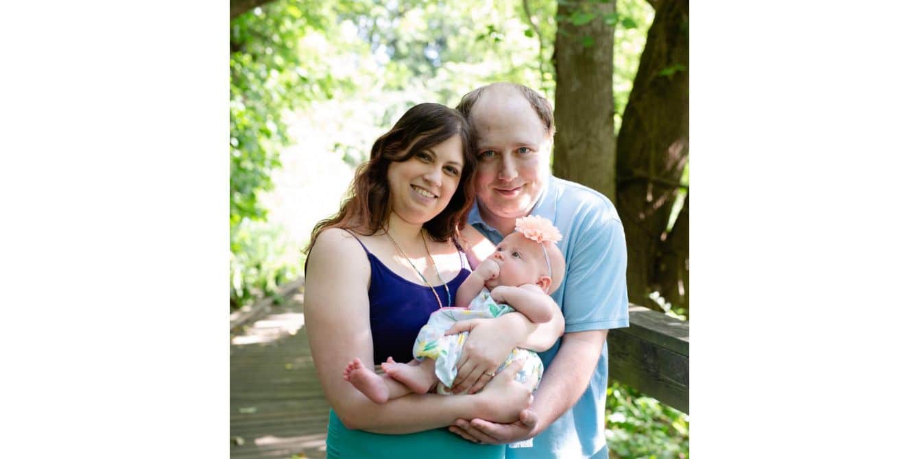 family picture of a mom holding her daughter and dad - essay on postpartum depression and covid