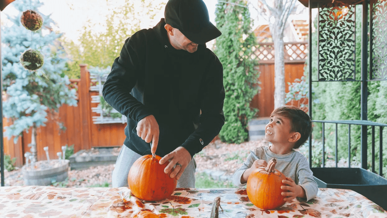 dad and son carving pumpkins
