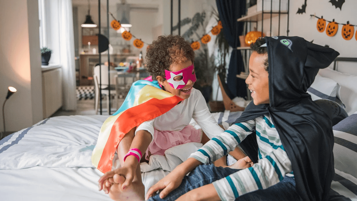 kids in halloween costumes inside their house