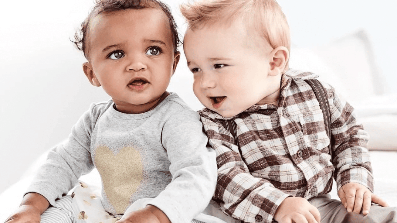 two babies in adorable clothes