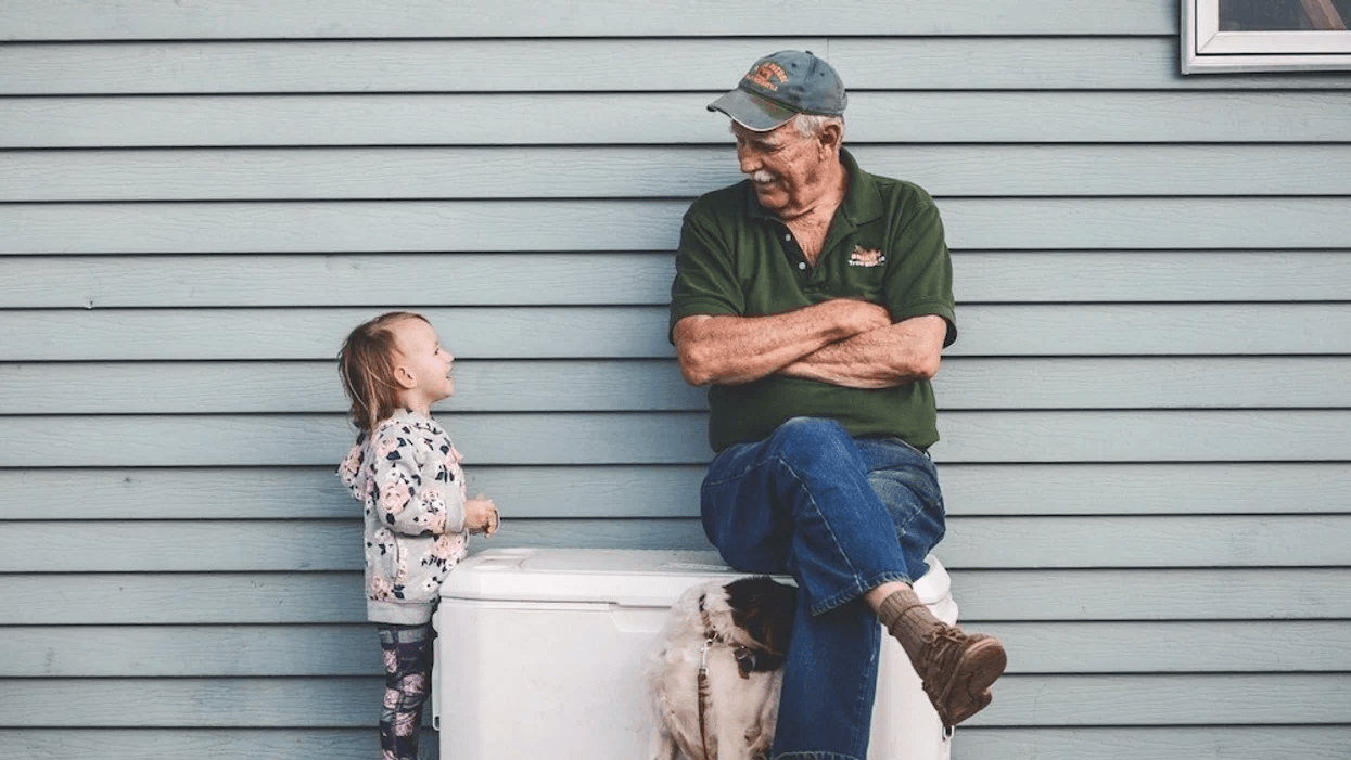 little girl talking to an older man