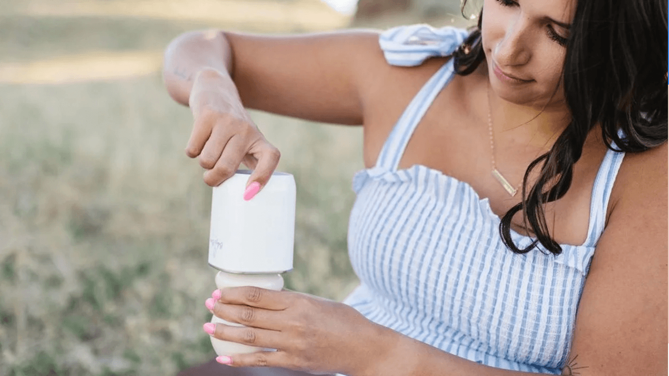 mom using a portable bottle warmer