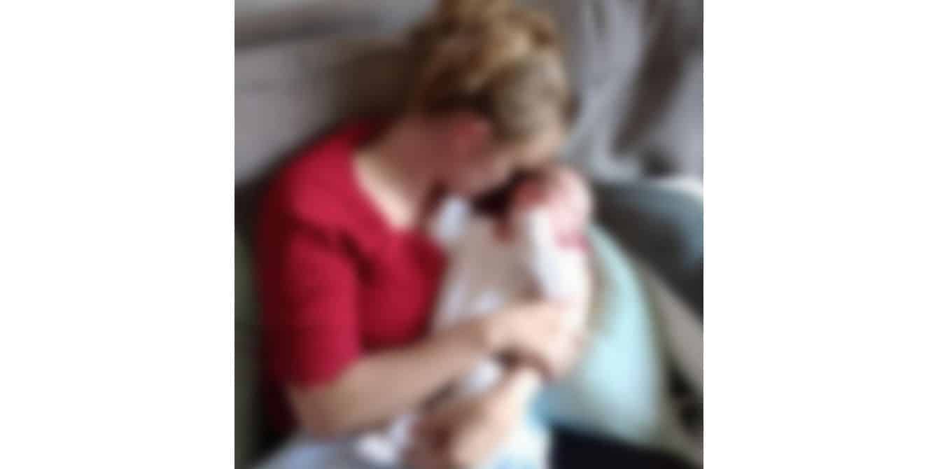 blurry image of a mom holding her baby - essay on husband's postpartum depression