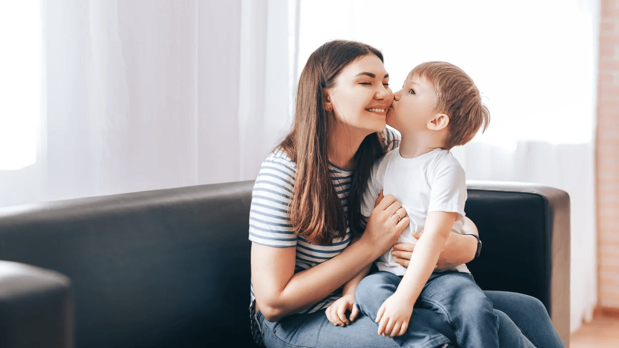 little boy kissing mom on the cheek