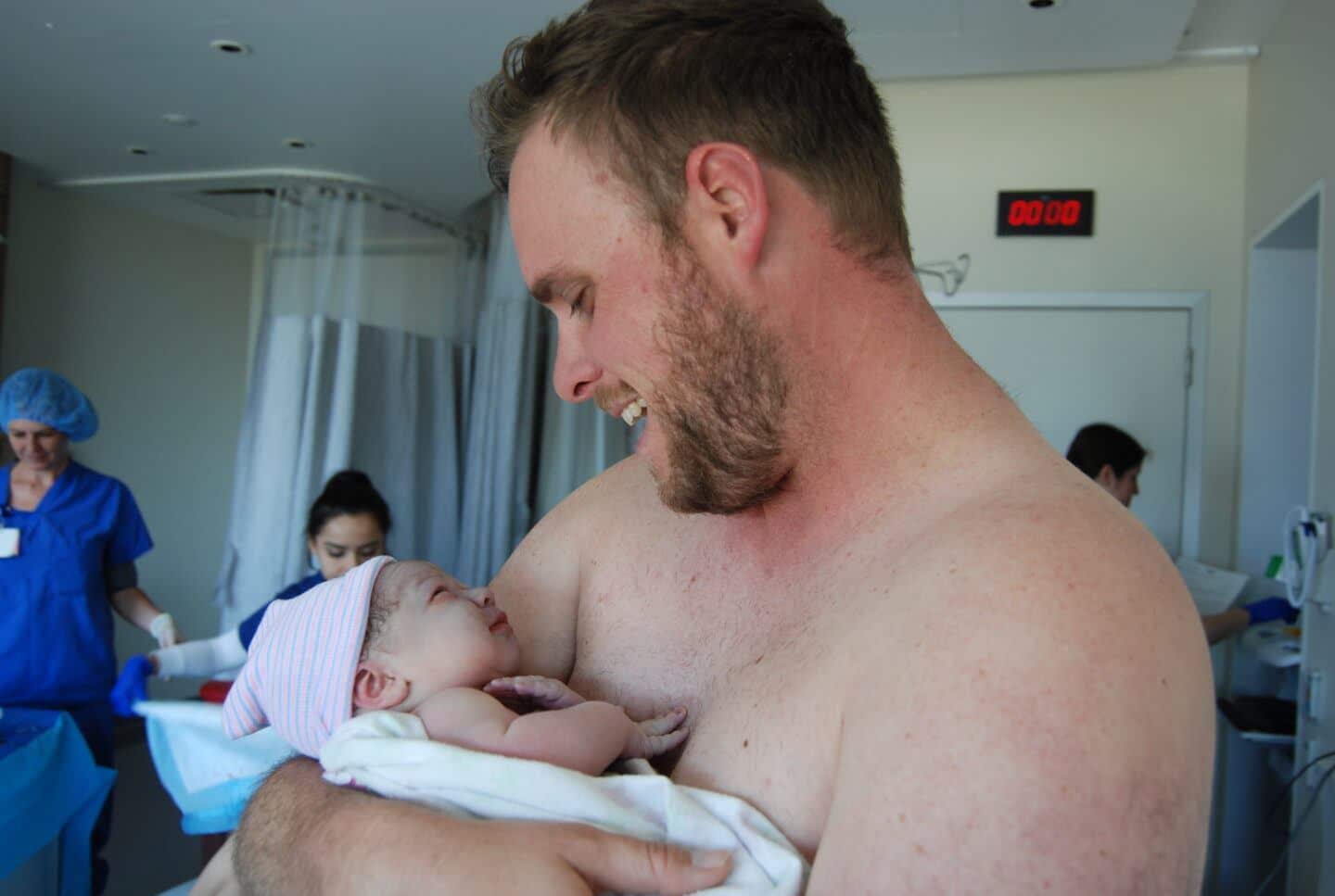 dad holding newborn baby in the hospital