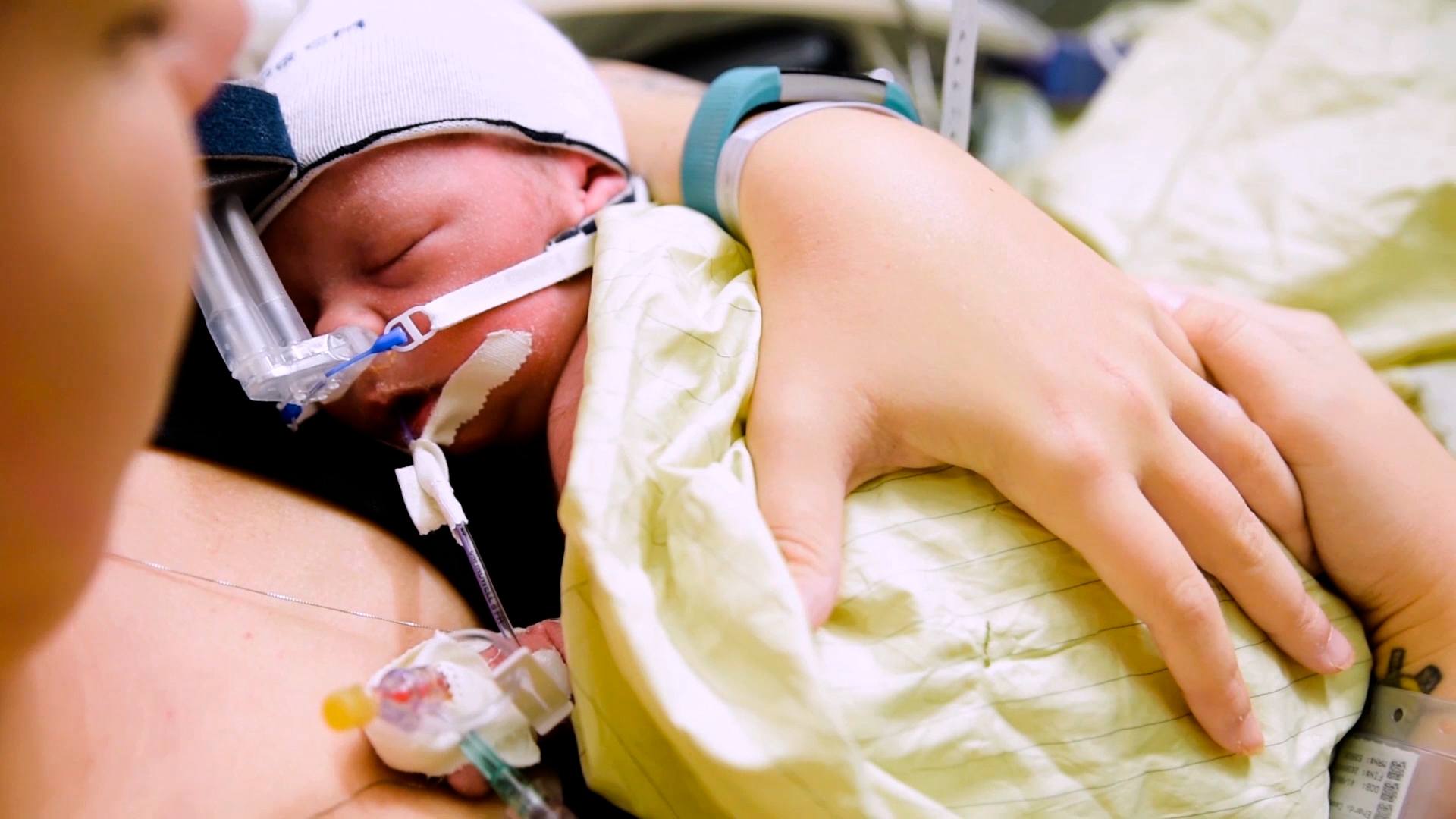 mom holding baby in the NICU