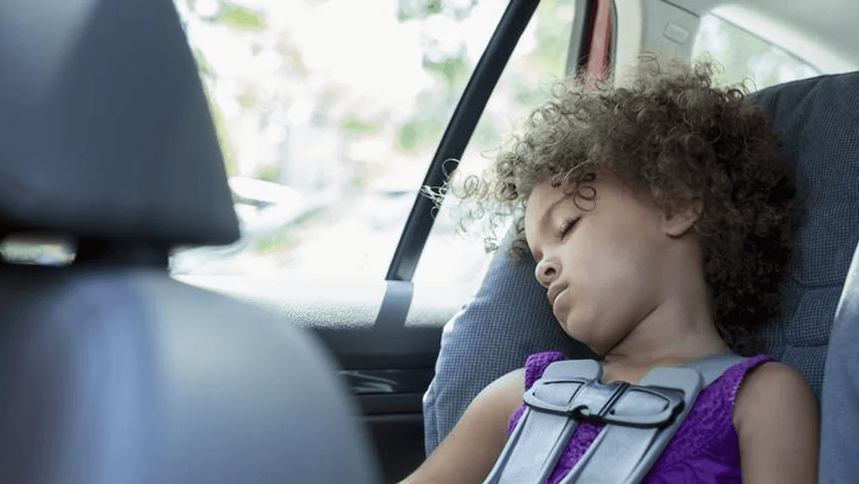 little girl sleeping in her car seat - booster seat